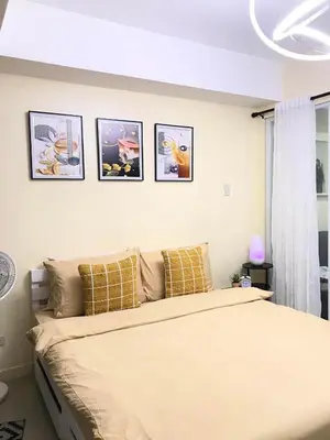 a bedroom with a bed with four pictures on the wall at Positano Tower Beach view with PS4 - Azure Parañaque Resort in Manila