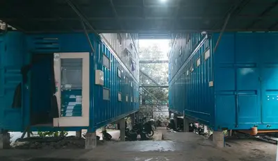 two blue train cars sitting inside of a building at CitiHub Shaw Santa Mesa in Manila