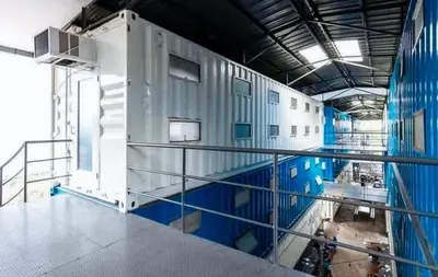 a large swimming pool in a building with blue walls at CitiHub Shaw Santa Mesa in Manila