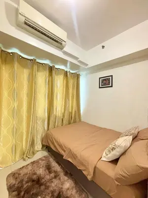 a bedroom with a bed and a air conditioner at Jazz Luxe Getaway in Manila
