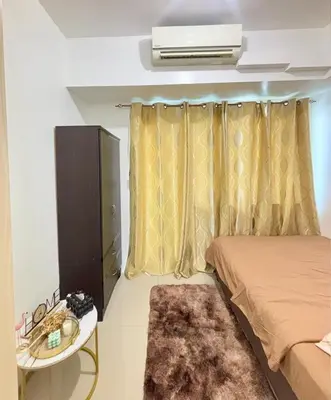 a small bedroom with a bed and a table and a bed sidx sidx at Jazz Luxe Getaway in Manila