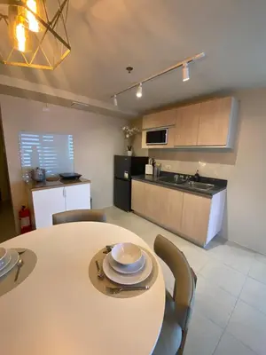 a kitchen and dining room with a table and chairs at EDSA Heights Penthouse Unit 3306 Ama Tower Residences in Manila