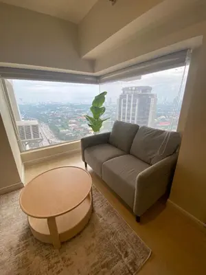 a living room with a couch and a large window at EDSA Heights Penthouse Unit 3306 Ama Tower Residences in Manila