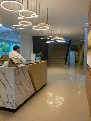 a man sitting at a desk in an office with a laptop at EDSA Heights Penthouse Unit 3306 Ama Tower Residences in Manila
