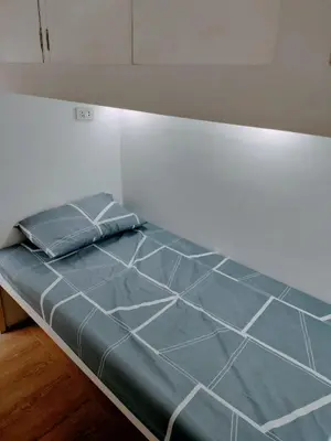 a bed in a room with a blue mattress at Nemar Building Solo Room w AC in Manila