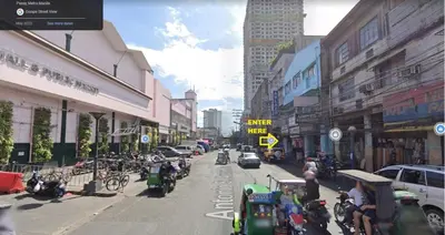 a busy city street with cars and people on motorcycles at Nemar Building Solo Room w AC in Manila