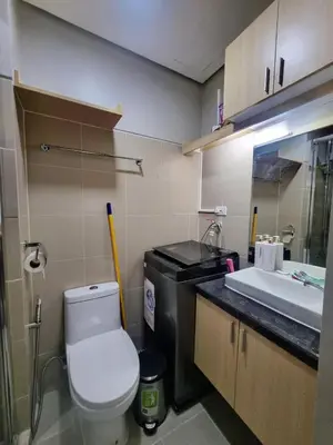 a small bathroom with a toilet and a sink at Luxe Studio at Fame Residences Malls, CBDs and More in Manila