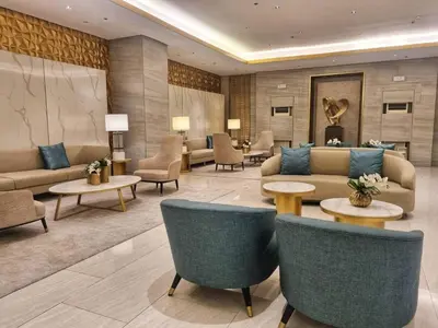 a hotel lobby with couches and chairs and tables at Luxe Studio at Fame Residences Malls, CBDs and More in Manila