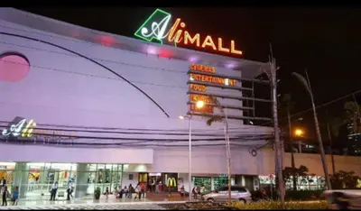 a mall with a neon sign on the side of it at 1 BR Luxury Apartment in Manila