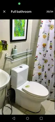 a bathroom with a white toilet and a sink at 1 BR Luxury Apartment in Manila