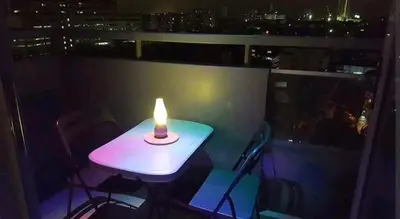 a small table with a candle on a balcony at 1 BR Luxury Apartment in Manila