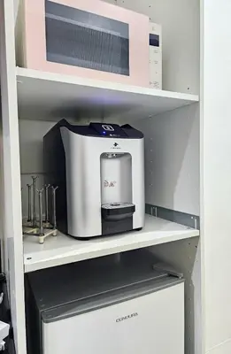 a coffee maker on a shelf in a kitchen at Cozy Modern Condotel in Pasay Near MOA & Airport in Manila