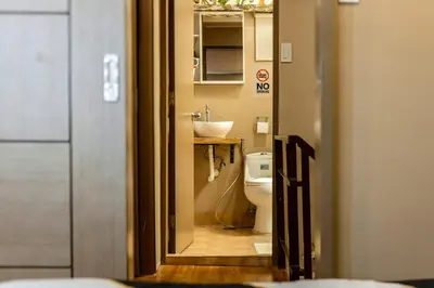 a small bathroom with a toilet and a sink at Atman Suite 2 BR 2 Bathroom Fort Victoria BGC Taguig in Manila