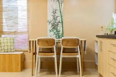 two chairs sitting at a table in a kitchen at Atman Suite 2 BR 2 Bathroom Fort Victoria BGC Taguig in Manila