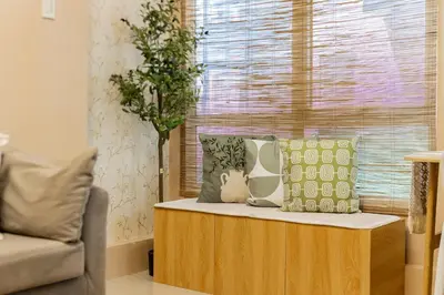 a table with pillows on it in a living room at Atman Suite 2 BR 2 Bathroom Fort Victoria BGC Taguig in Manila