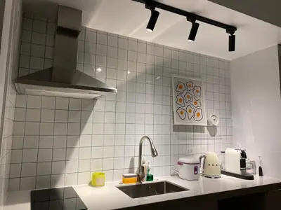 a kitchen with a sink and a stove at San Lorenzo Place Condominium Makati City in Manila