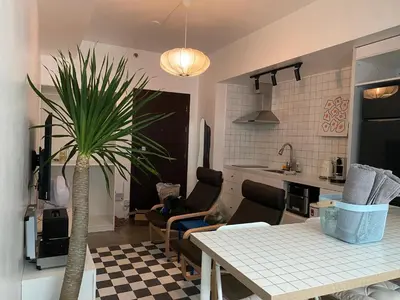 a living room with a table and a palm tree at San Lorenzo Place Condominium Makati City in Manila