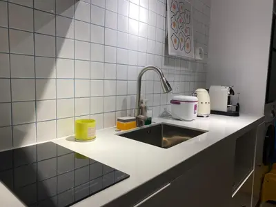a kitchen counter with a sink and appliances on it at San Lorenzo Place Condominium Makati City in Manila