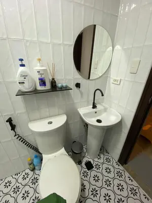 a bathroom with a toilet and a sink at San Lorenzo Place Condominium Makati City in Manila