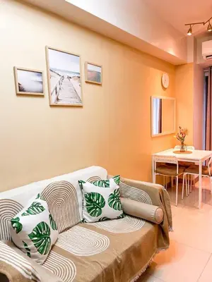 a living room with a couch and a table at Staycation in Diamond in Manila