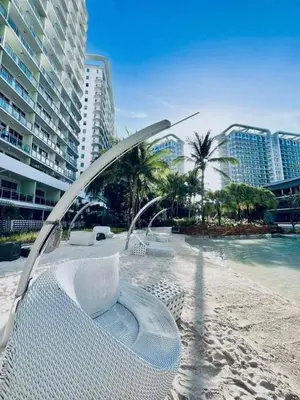 a view of a beach with a bench and a pool at Staycation in Diamond in Manila