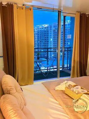 a bedroom with a bed with a view of a city at Azure Staycation by Casa Tremora in Manila