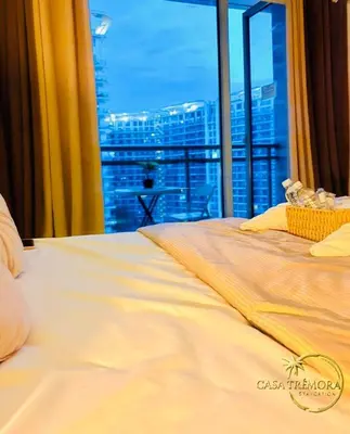 a bedroom with a bed with a view of a city at Azure Staycation by Casa Tremora in Manila