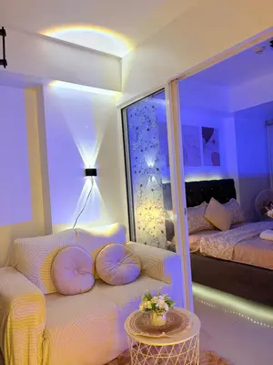 a room with a couch and a bed and a table at Azure Staycation by Casa Tremora in Manila