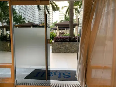 an open door to a building with a sign on it at Kathys Crib 11th flr 2 at Shell Residence pool view in Manila