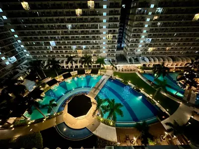 an overhead view of a large building with a large pool at Kathys Crib 11th flr 2 at Shell Residence pool view in Manila