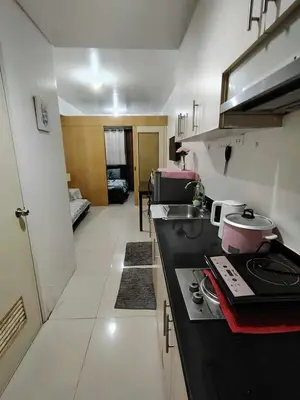 a kitchen with a counter and a stove top oven at Sea Residence Condotel Pasay in Manila