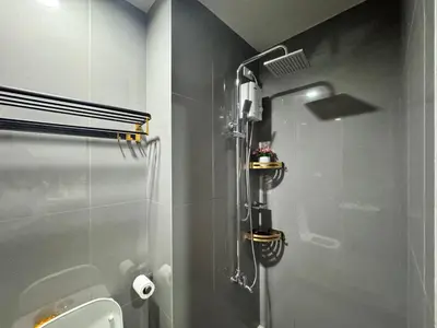 a shower stall in a bathroom with a toilet at Condo in Makati in Manila