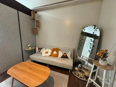 a small room with a couch and a mirror at Condo in Makati in Manila