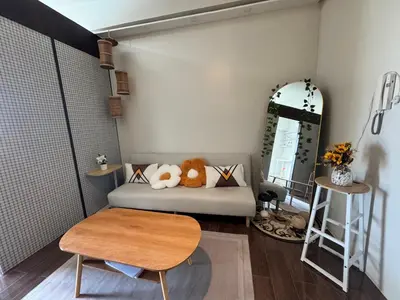 a room with a bed and a table and a mirror at Condo in Makati in Manila