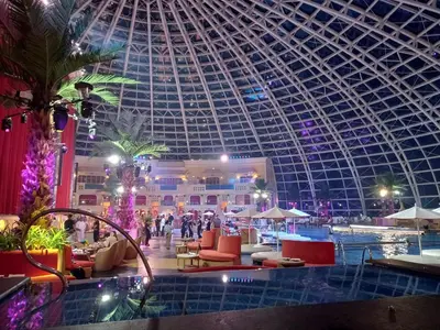 a large building with a domed ceiling and a swimming pool at Luxurious Modern 2 Bedrooms Facing Manila Bay Sunset, Airports, Okada, Solaire, MOA with free parking in Manila