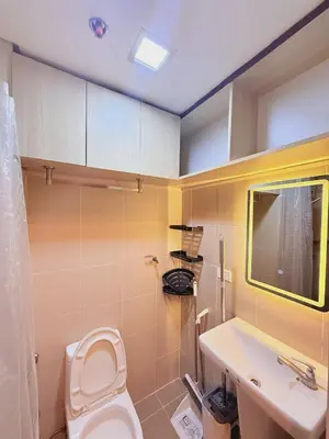 a bathroom with a toilet and a sink at Cozy Minimalist Staycation in Manila
