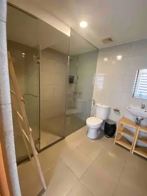 a bathroom with a shower and a toilet and a sink at EDSA Heights Ama Tower Unit 3305 Loft Penthouse Unit in Manila