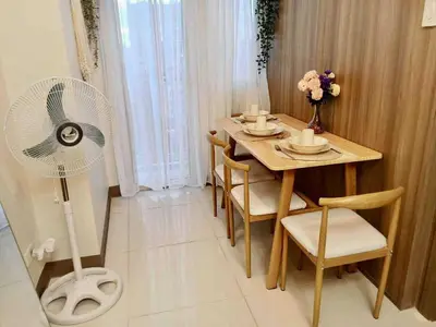 a dining room with a table with a fan at Horizon Haven in Manila