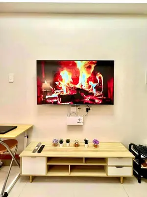 a living room with a tv hanging on a wall at Horizon Haven in Manila