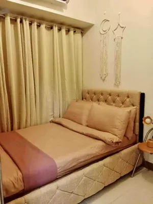 a bed in a room with curtains and a bed sidx sidx sidx at Horizon Haven in Manila
