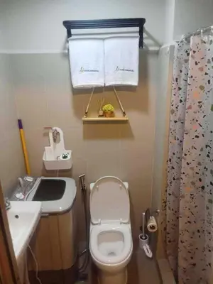 a small bathroom with a toilet and a sink at Horizon Haven in Manila