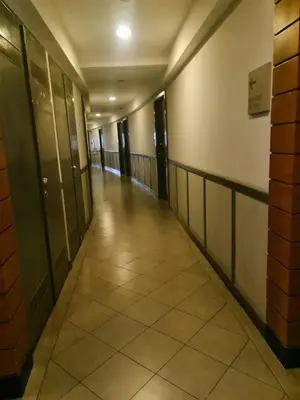 an empty hallway of a building with doors and tile floors at Condominium unit Knightsbridge Residences, Makati in Manila