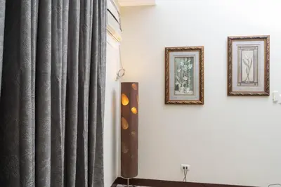 two framed pictures on a wall next to a curtain at 101 Newport Boulevard 1BR with Parking - Pasay City in Manila