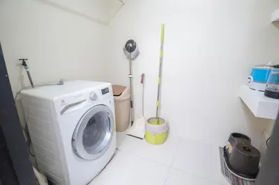 a washing machine in a bathroom with a toilet at 101 Newport Boulevard 1BR with Parking - Pasay City in Manila