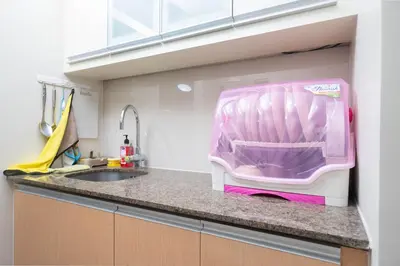 a pink appliance sitting on top of a kitchen counter at 101 Newport Boulevard 1BR with Parking - Pasay City in Manila