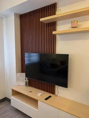 a flat screen tv on a wall in a room at Staycation at JG in Manila