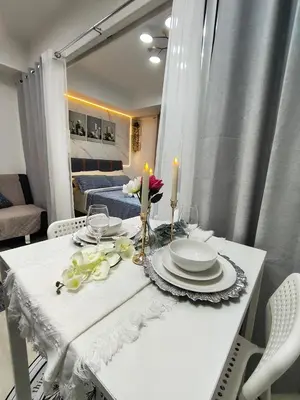 a white table with plates and candles on it at City Escape in Manila