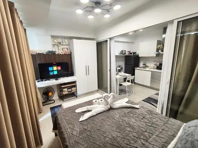 a bedroom with a bed with a stuffed animal on it at City Escape in Manila