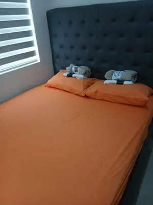 a bed with two stuffed animals sitting on top of it at Non bookable in Manila