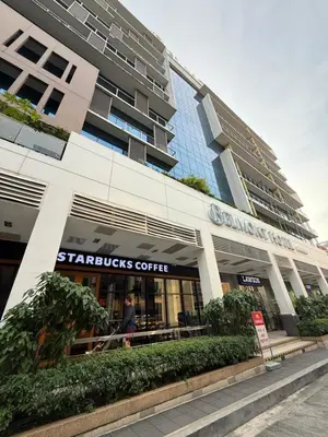 a building with a starbucks coffee sign in front of it at One Palmtree Villas in Manila